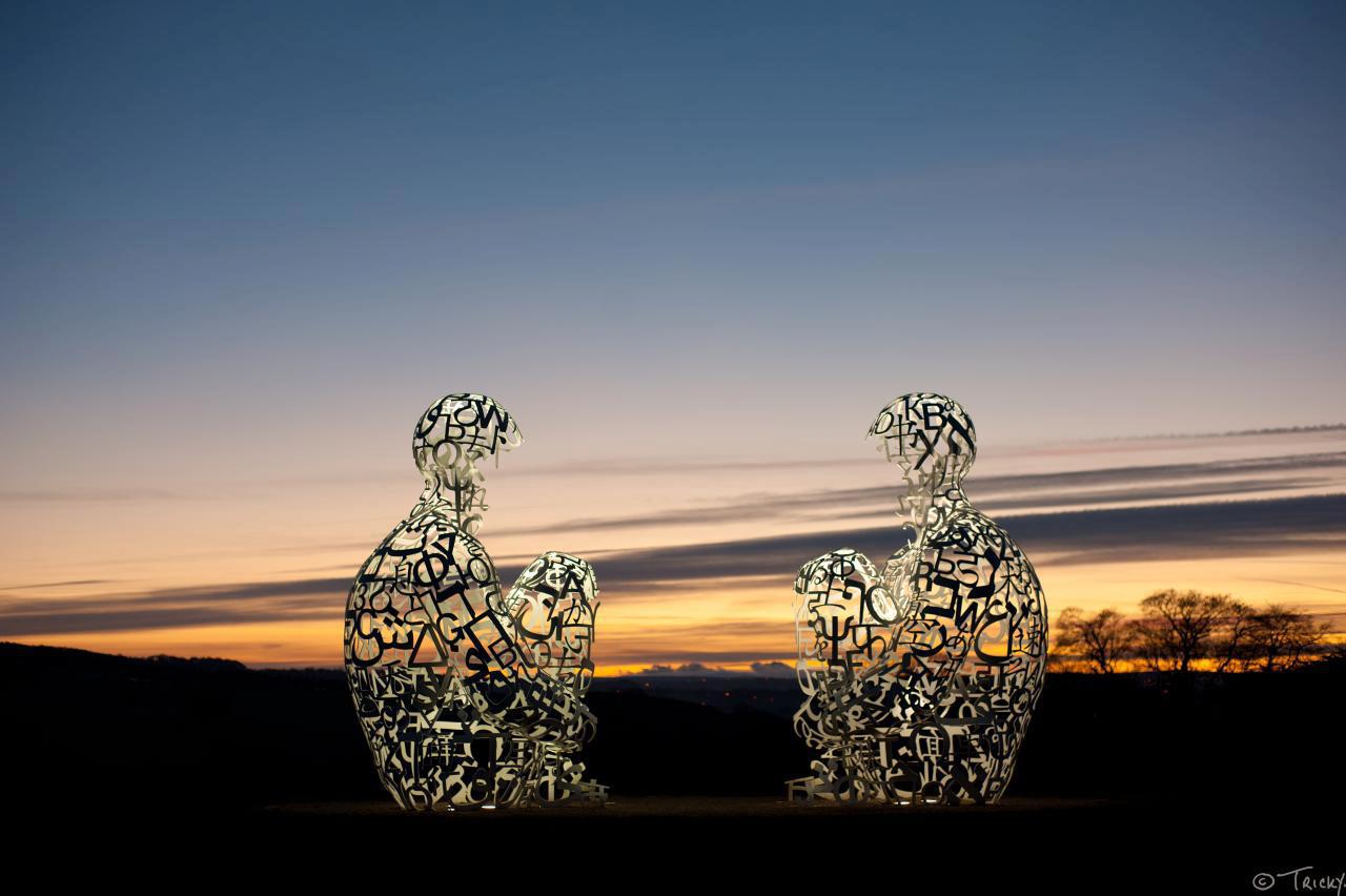 An artwork by Jaume Plensa at the Yorkshire Sculpture Park, at Dusk.