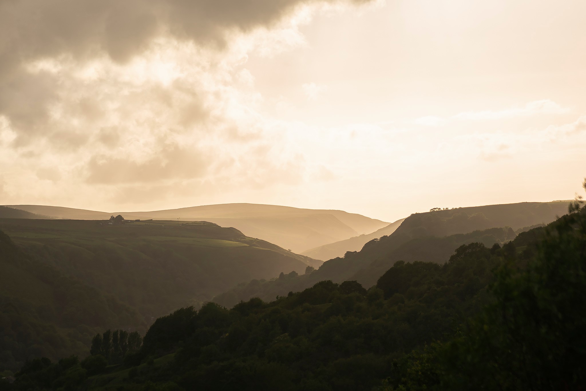 A high-contrast view looking up the valley from Todmorden with graduated silhouttes of the valley sides